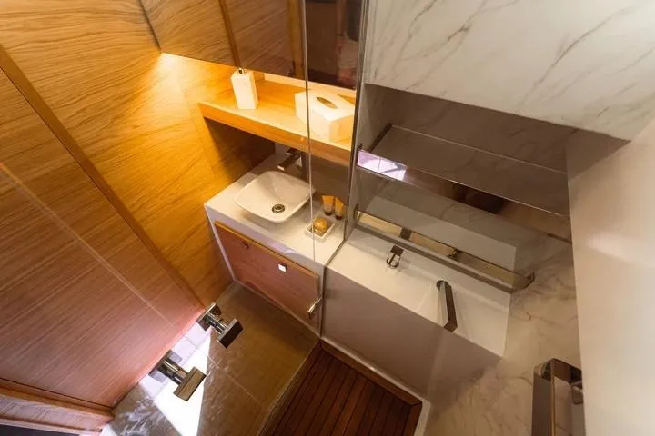  Yacht Photos Pics Luxurious bathroom interior of 2026 De Antonio Yachts D50, featuring modern fixtures and wood accents.