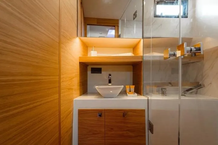  Yacht Photos Pics Luxurious bathroom interior of 2026 De Antonio Yachts D50, featuring modern wood and glass design.