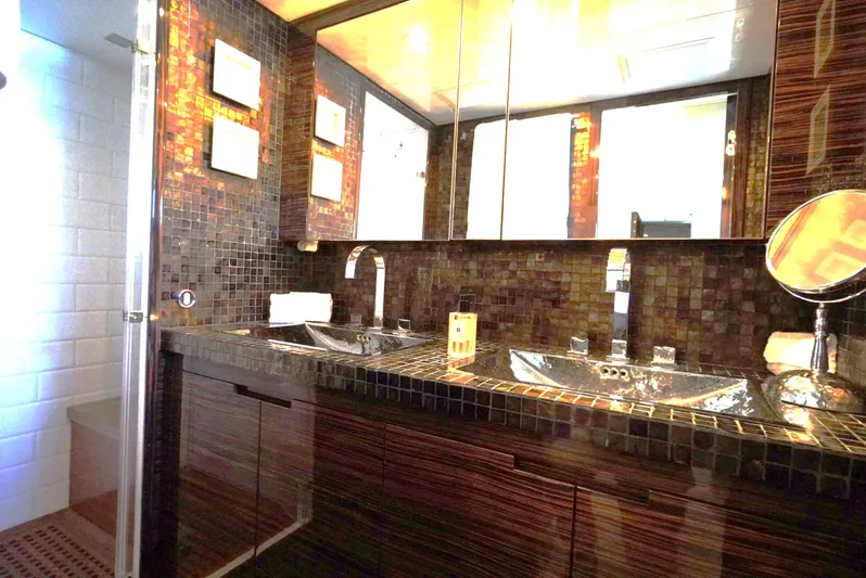 Go Yacht Photos Pics Luxurious bathroom with dual sinks and mosaic tiles on a 2008 Leopard 34 yacht.