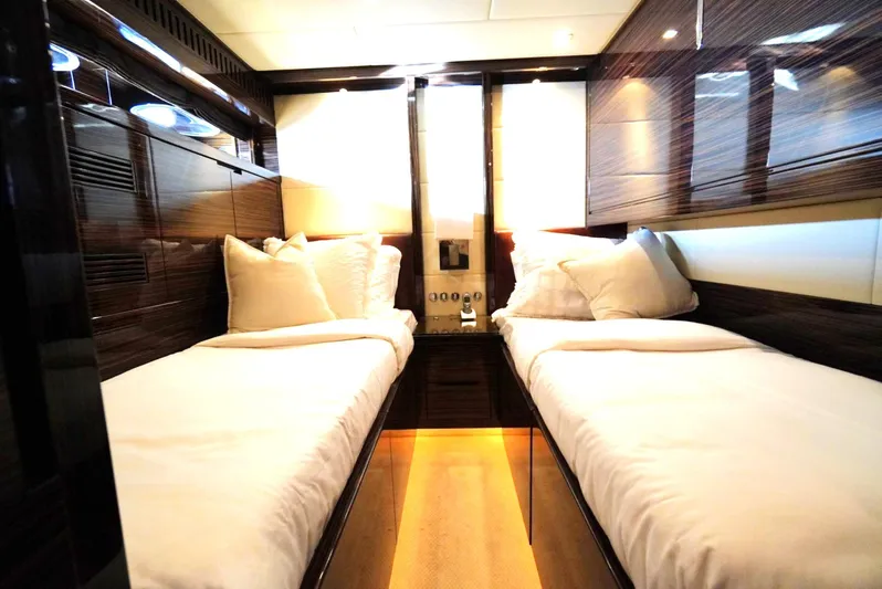 Go Yacht Photos Pics Luxurious twin cabin interior on 2008 Leopard 34 yacht, featuring sleek wood paneling and plush bedding.
