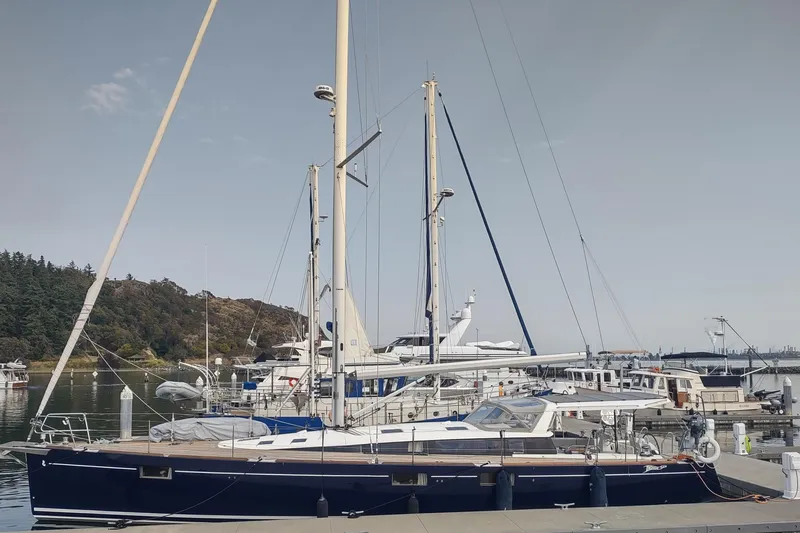 Indigo Sea Yacht Photos Pics 2018 Beneteau Sense 57 yacht docked at a marina, surrounded by other boats.