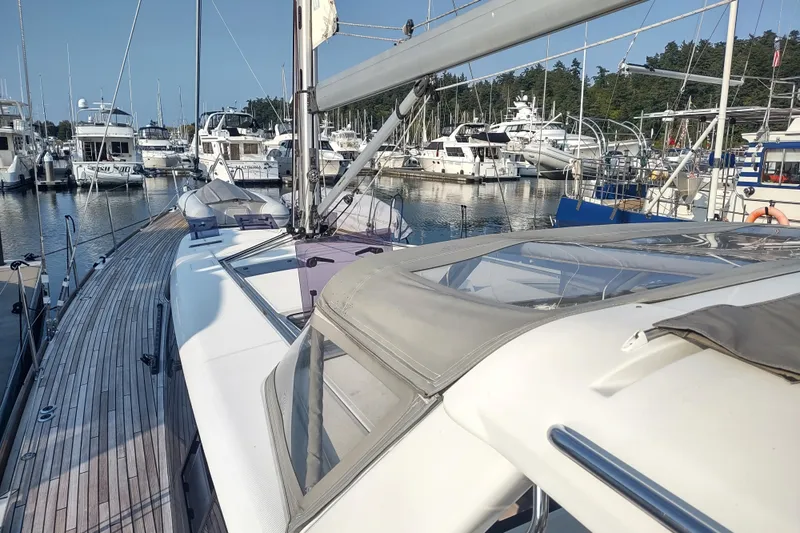 Indigo Sea Yacht Photos Pics 2018 Beneteau Sense 57 yacht docked in a marina, surrounded by other boats.