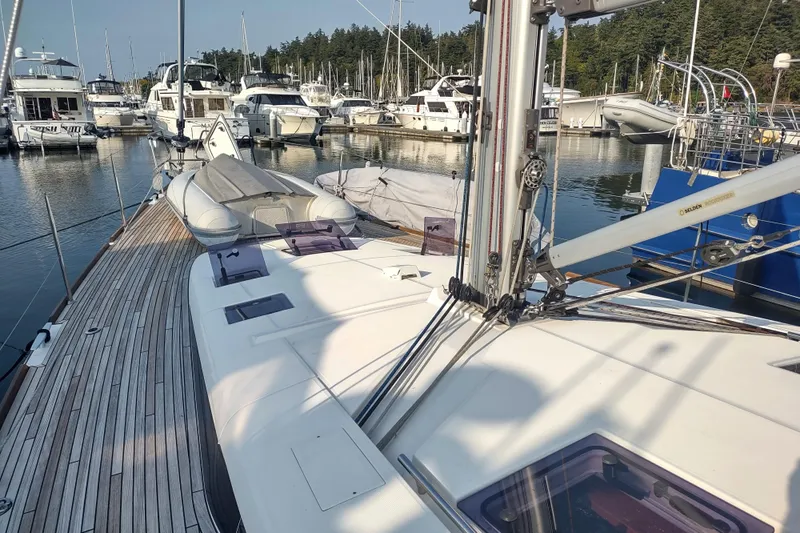 Indigo Sea Yacht Photos Pics 2018 Beneteau Sense 57 yacht docked at marina with inflatable dinghy on deck.