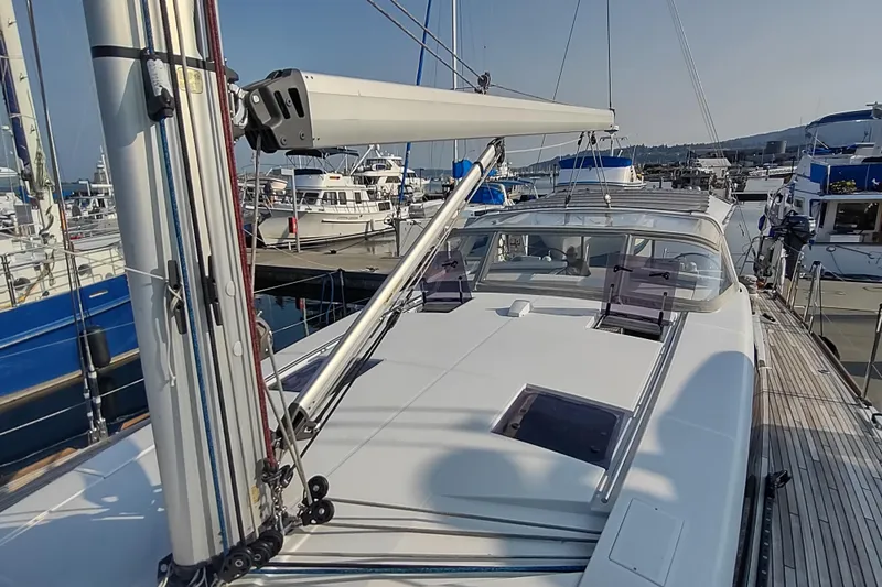 Indigo Sea Yacht Photos Pics 2018 Beneteau Sense 57 yacht docked at marina, showcasing sleek deck design.