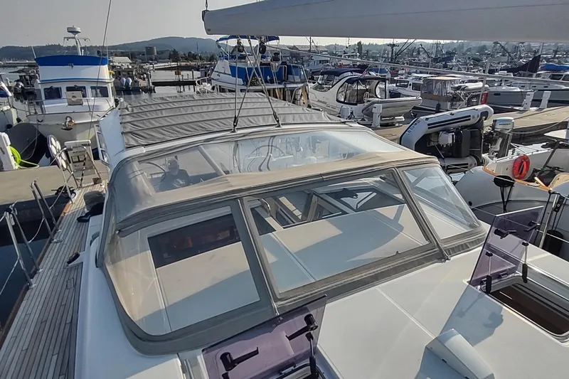Indigo Sea Yacht Photos Pics 2018 Beneteau Sense 57 yacht docked at marina, showcasing sleek design and spacious deck.