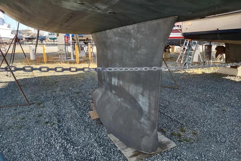 Indigo Sea Yacht Photos Pics Keel of 2018 Beneteau Sense 57 sailboat in a boatyard setting.