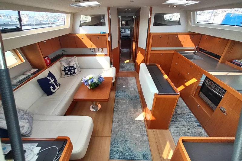 Indigo Sea Yacht Photos Pics Luxurious interior of 2018 Beneteau Sense 57 yacht with elegant wood finishes and modern amenities.