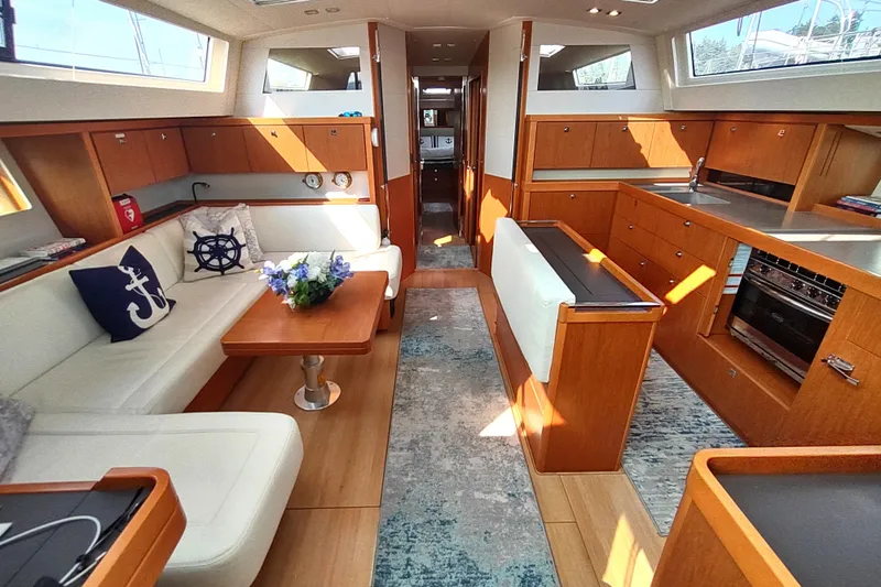 Indigo Sea Yacht Photos Pics Luxurious interior of 2018 Beneteau Sense 57 yacht with elegant wood finishes and modern amenities.