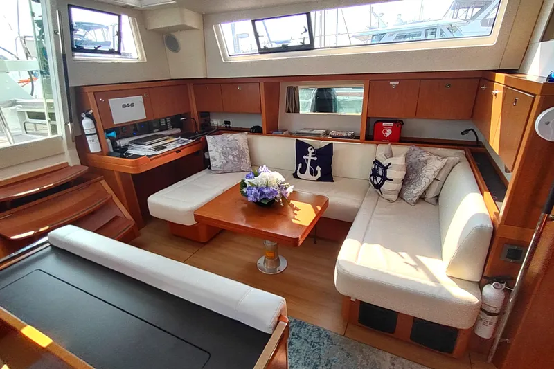 Indigo Sea Yacht Photos Pics Interior of 2018 Beneteau Sense 57 yacht with cozy seating and nautical decor.