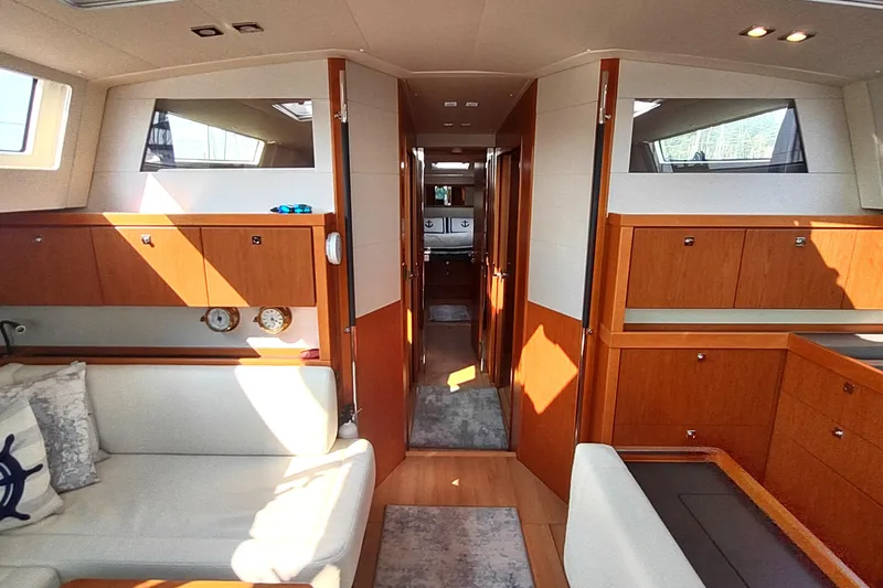 Indigo Sea Yacht Photos Pics Luxurious interior of 2018 Beneteau Sense 57 yacht with elegant wood cabinetry and seating.
