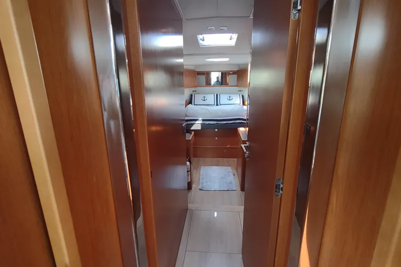 Indigo Sea Yacht Photos Pics Interior view of 2018 Beneteau Sense 57 yacht cabin with wooden finish.