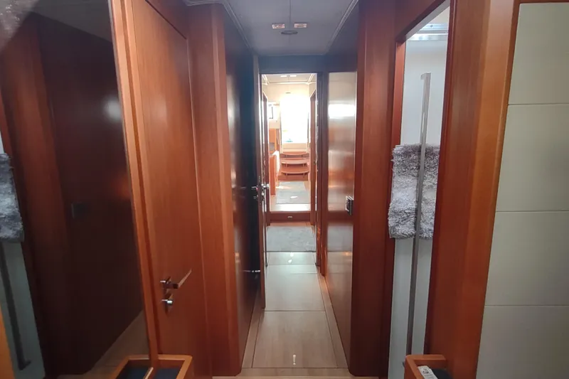 Indigo Sea Yacht Photos Pics Interior hallway of 2018 Beneteau Sense 57 yacht with wooden finishes.