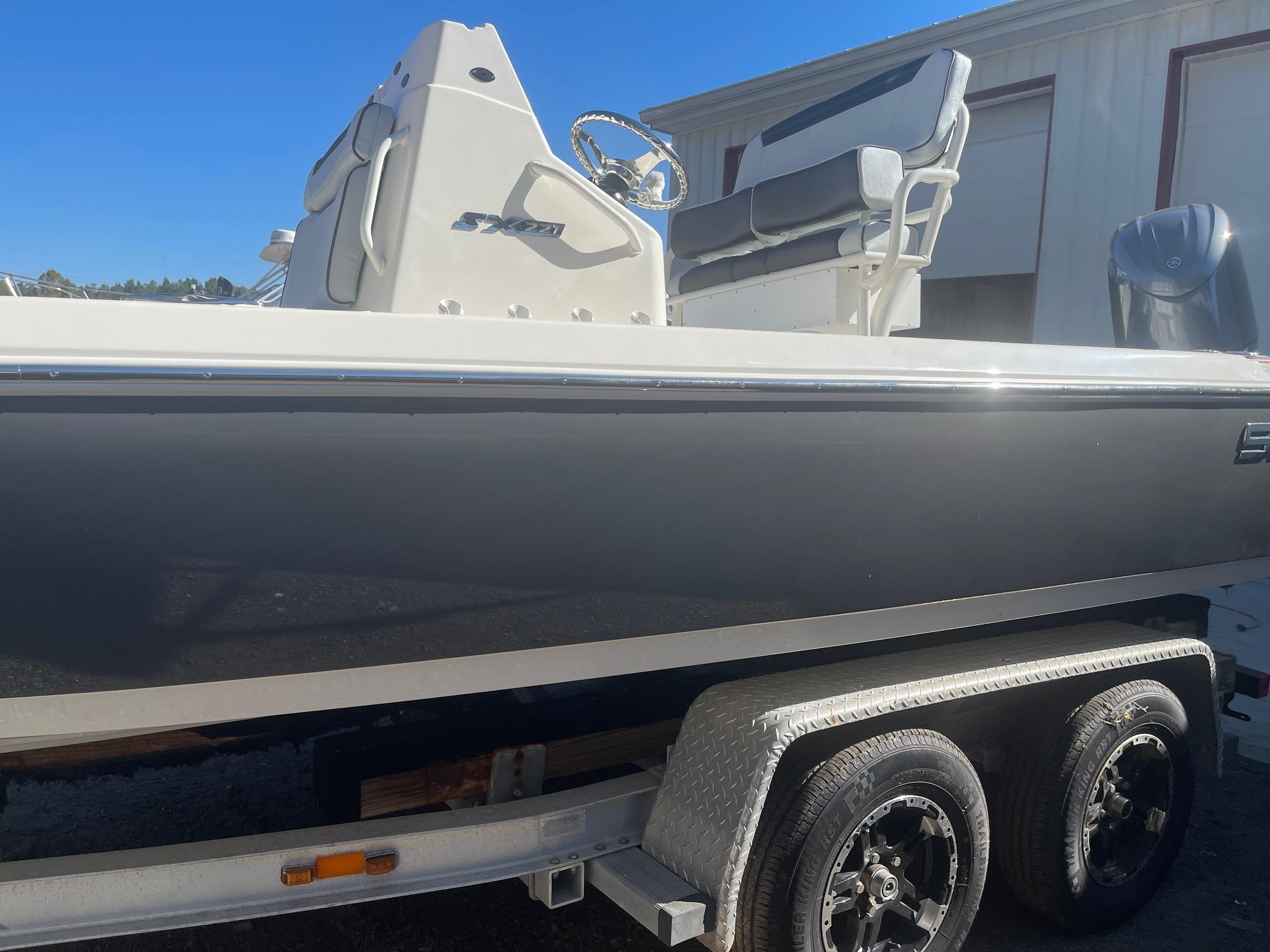 2025 Skeeter SX221 boat on trailer, side view, outdoors, clear sky.