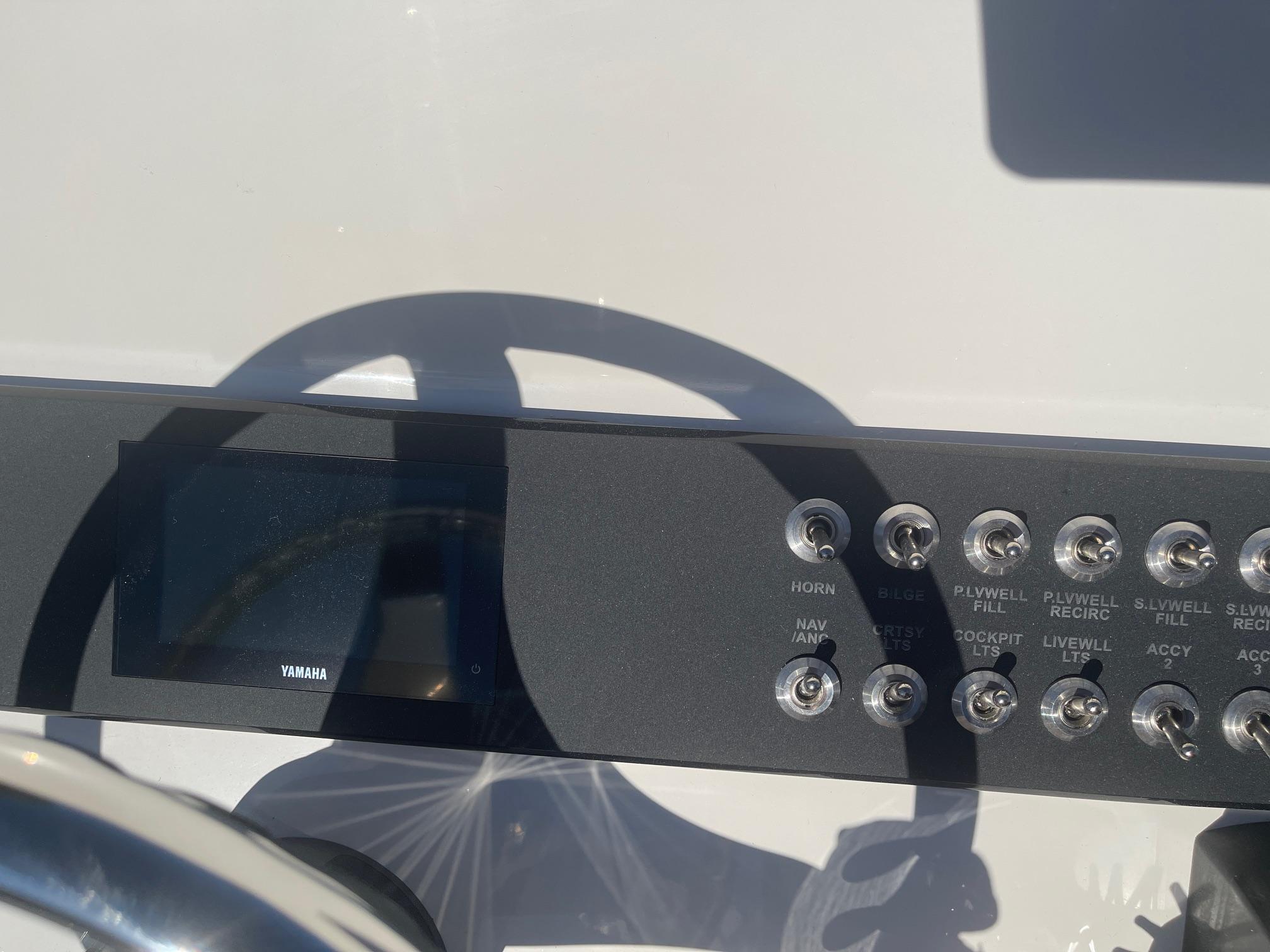 Control panel of 2025 Skeeter SX221 boat with buttons and display.
