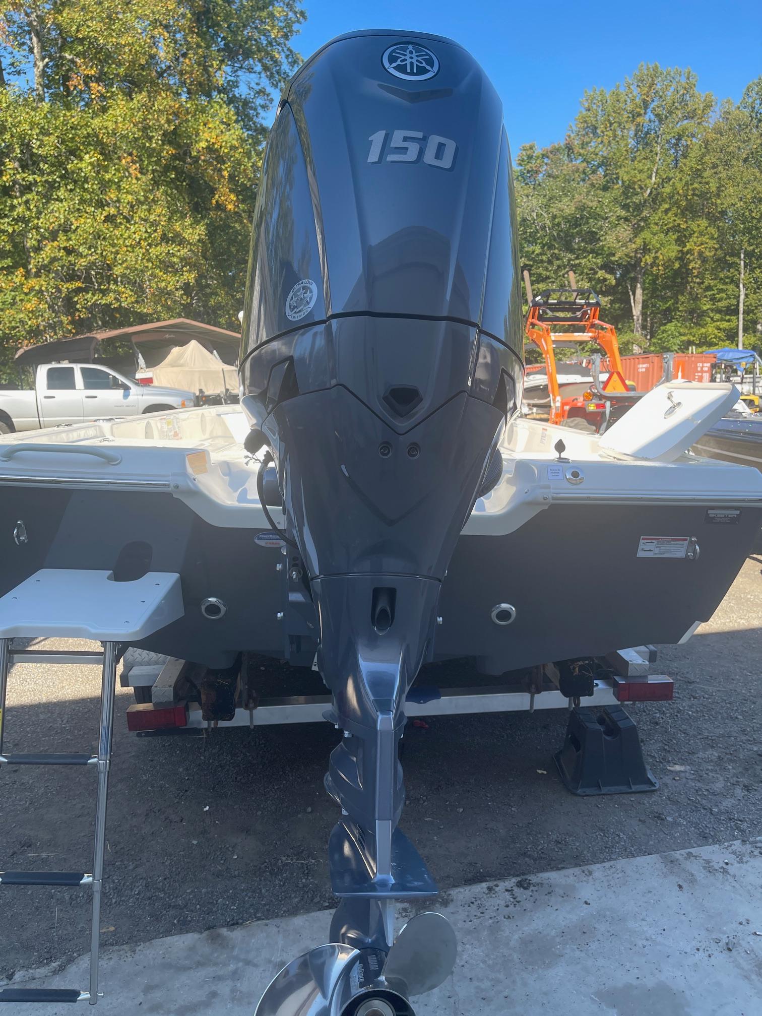 2025 Skeeter SX221 boat with Yamaha 150 outboard motor, parked outdoors.