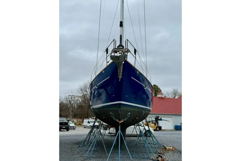 Mavi Yacht Photos Pics 1991 Oyster 49 sailboat on stands, blue hull, overcast sky, marina setting.