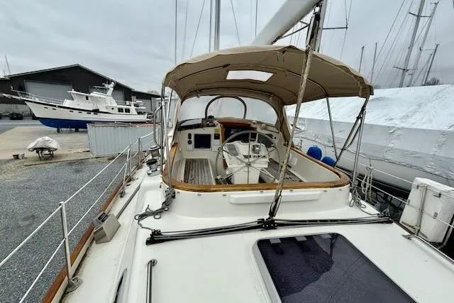 Mavi Yacht Photos Pics 1991 Oyster 49 sailboat with covered cockpit, docked in a marina.