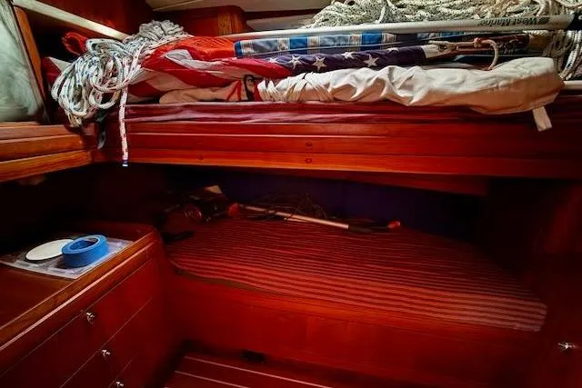 Mavi Yacht Photos Pics Interior of 1991 Oyster 49 yacht with wooden bunk beds and nautical equipment.