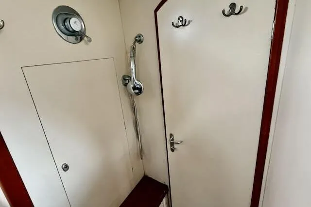 Mavi Yacht Photos Pics Interior of 1991 Oyster 49 yacht with shower and hooks on door.