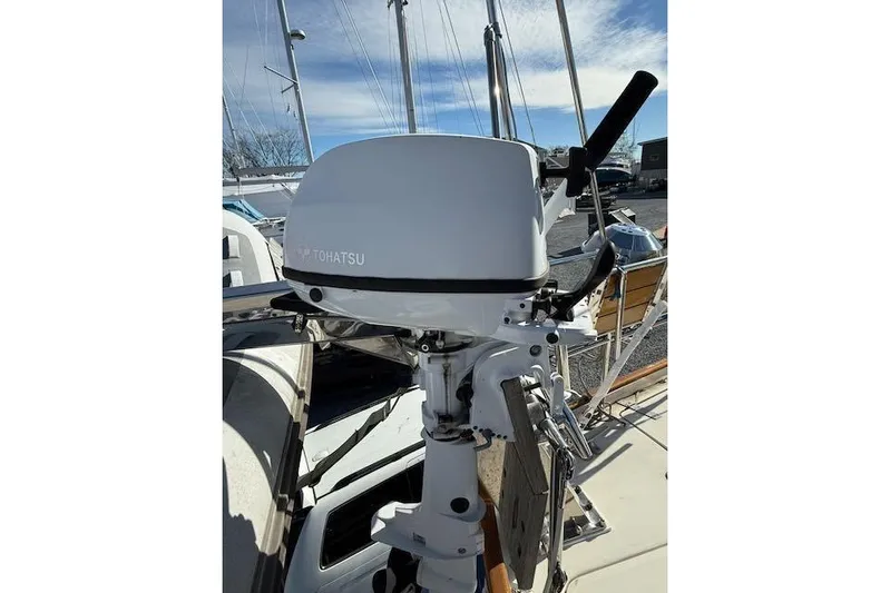 Mavi Yacht Photos Pics Tohatsu outboard motor on 1991 Oyster 49 sailboat, docked under clear sky.