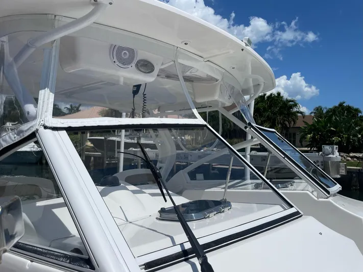  Yacht Photos Pics 2017 Edgewater 280 CX boat with clear windshield and blue sky background.