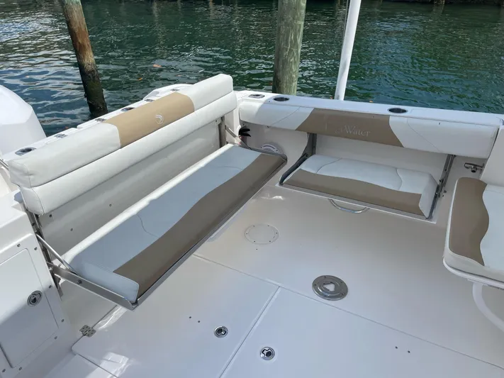  Yacht Photos Pics 2017 Edgewater 280 CX boat interior with beige seating and water backdrop.