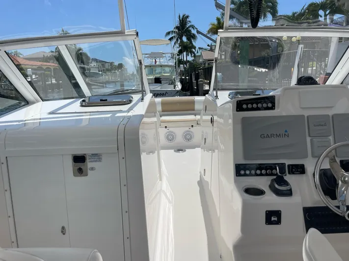  Yacht Photos Pics 2017 Edgewater 280 CX boat cockpit with Garmin navigation system and sleek white interior.