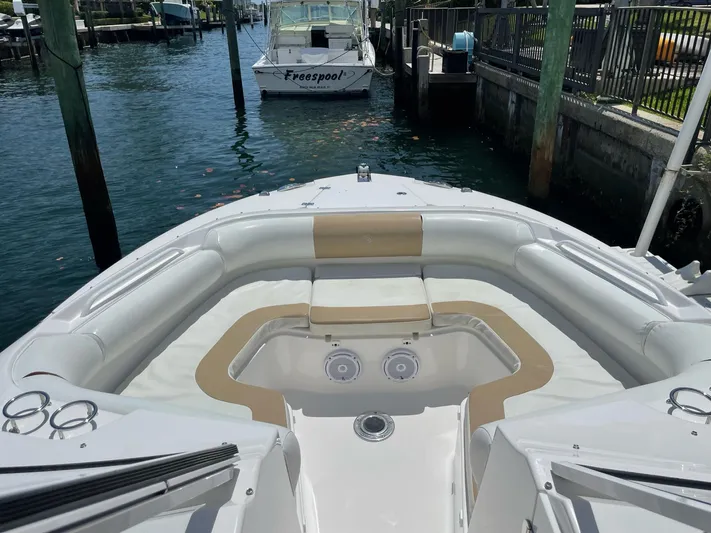  Yacht Photos Pics Edgewater 280 CX 2017 boat with spacious seating at a marina dock.