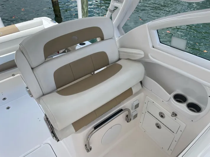  Yacht Photos Pics 2017 Edgewater 280 CX boat interior with cushioned seating and cup holders.