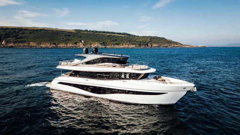 Chase Yacht Photos Pics Luxurious 2023 Princess X80 yacht cruising on open sea near scenic coastline.