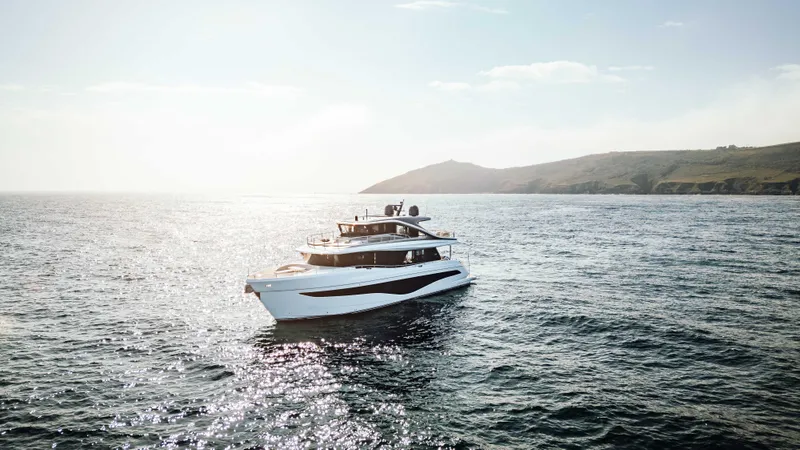 Chase Yacht Photos Pics 2023 Princess X80 yacht cruising on open sea with scenic coastal backdrop.