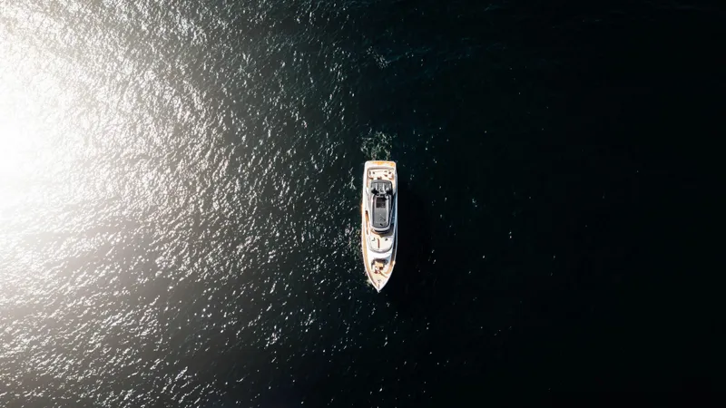 Chase Yacht Photos Pics Aerial view of 2023 Princess X80 yacht on dark water.