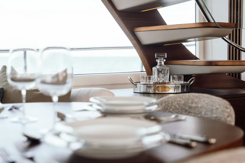 Chase Yacht Photos Pics Luxurious dining setup on 2023 Princess X80 yacht with elegant glassware and modern decor.