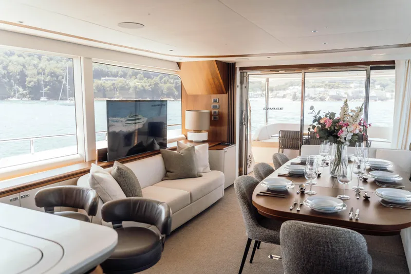 Chase Yacht Photos Pics Luxurious 2023 Princess X80 yacht interior with elegant dining area and scenic ocean views.