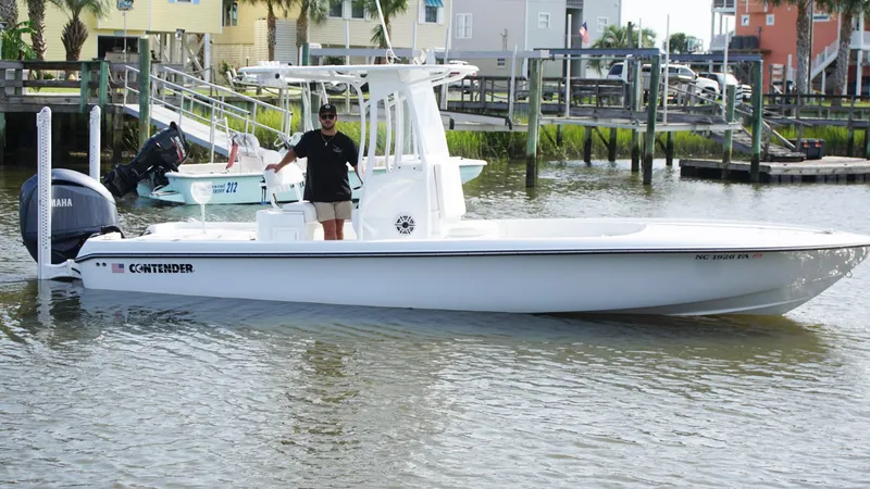  Yacht Photos Pics 2023 Contender 26 Bay boat on water near docks.
