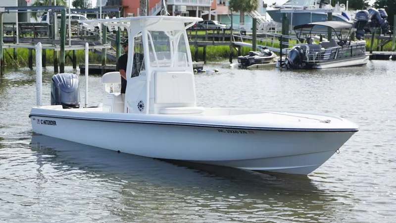  Yacht Photos Pics 2023 Contender 26 Bay boat on calm water near a marina.