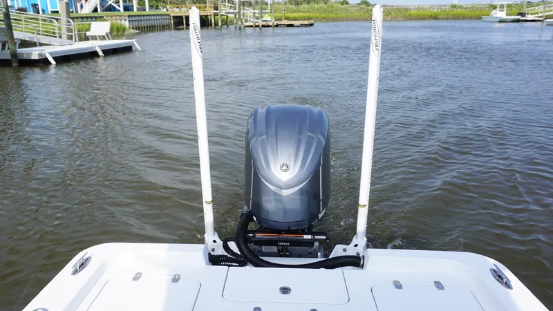  Yacht Photos Pics 2023 Contender 26 Bay boat with outboard motor on calm water.