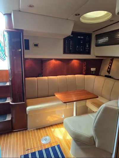No Interruptions Yacht Photos Pics 2000 Rampage 38 Express cabin interior with seating, table, and control panel.