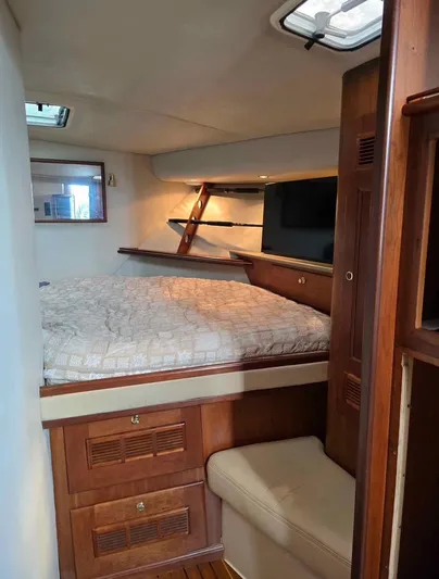 No Interruptions Yacht Photos Pics 2000 Rampage 38 Express cabin interior with bed, wooden cabinetry, and seating.