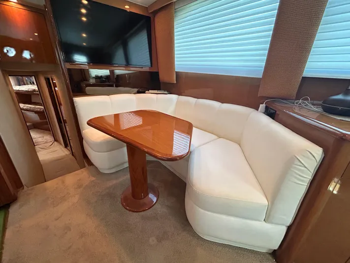  Yacht Photos Pics Luxurious interior of 2004 Viking 48C yacht with plush seating and elegant wooden table.