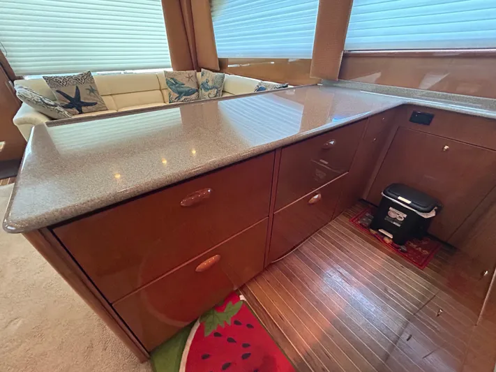  Yacht Photos Pics Luxurious interior of 2004 Viking 48C yacht with sleek cabinetry and cozy seating area.