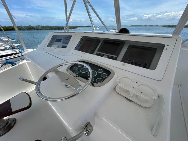  Yacht Photos Pics Helm of 2004 Viking 48C yacht with steering wheel and navigation controls.