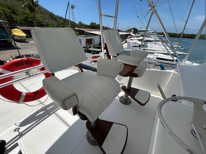  Yacht Photos Pics Captain's chairs on a 2004 Viking 48C yacht, docked near a marina.
