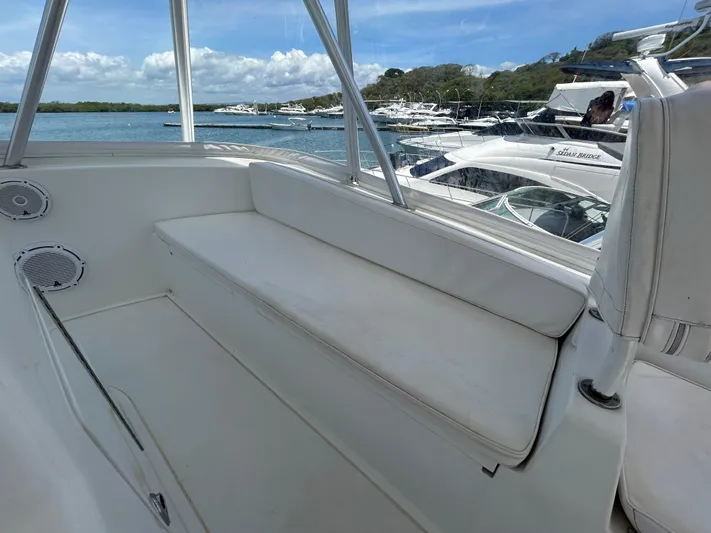  Yacht Photos Pics Interior view of a 2004 Viking 48C yacht with white seating and ocean backdrop.
