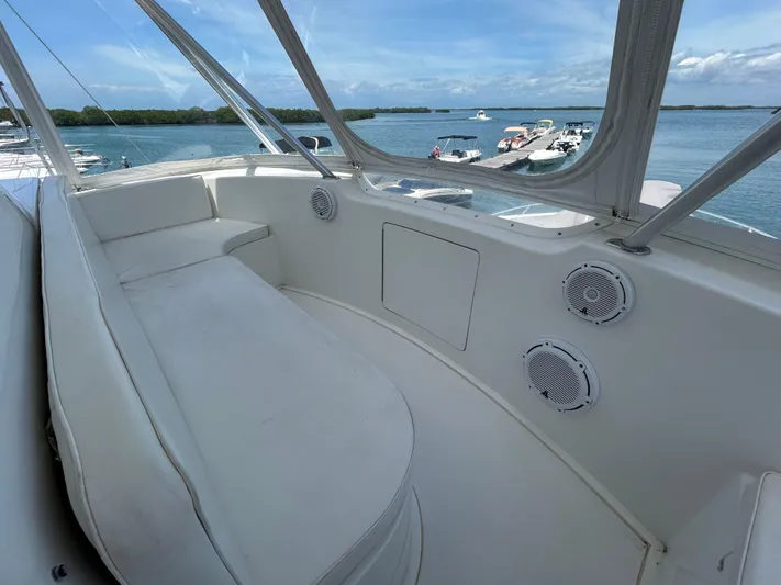  Yacht Photos Pics 2004 Viking 48C yacht interior with white seating, speakers, and ocean view.