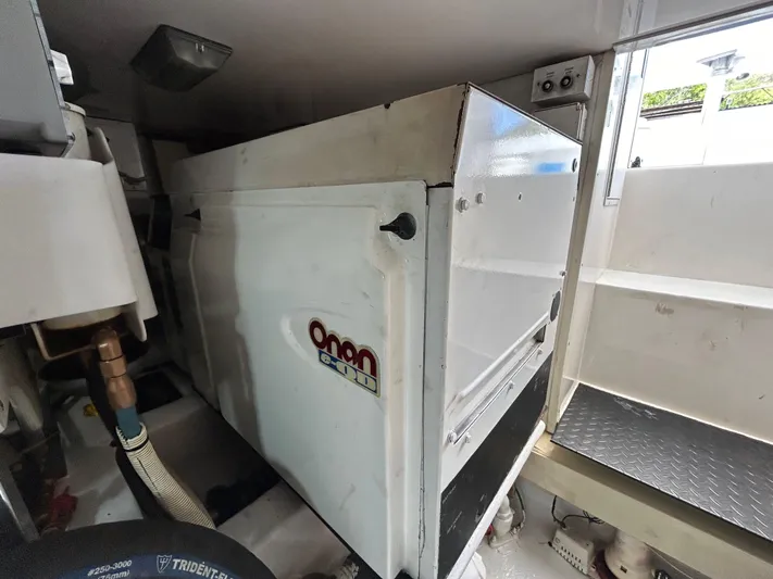  Yacht Photos Pics Engine room of 2004 Viking 48C with Onan generator visible.