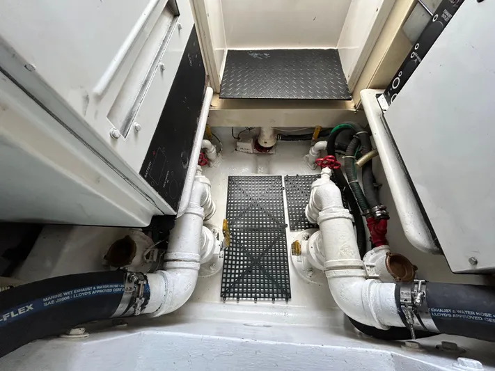  Yacht Photos Pics Engine room of a 2004 Viking 48C yacht, featuring pipes and equipment.