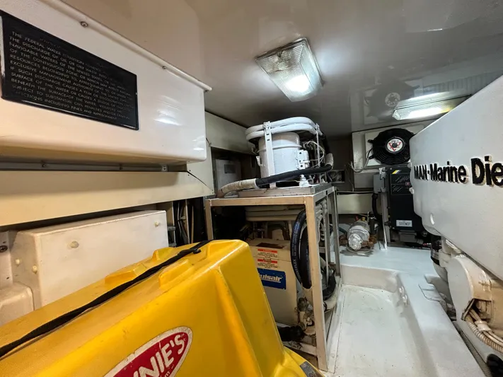 Yacht Photos Pics Engine room of a 2004 Viking 48C yacht, featuring marine diesel equipment and storage.