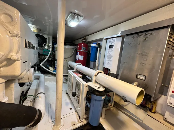  Yacht Photos Pics Engine room of 2004 Viking 48C yacht with mechanical equipment and control panels.