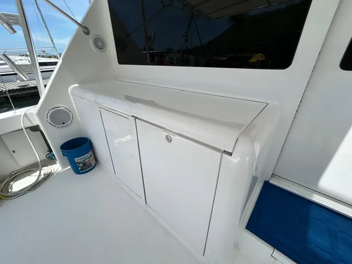  Yacht Photos Pics 2004 Viking 48C yacht deck with storage cabinet and marine speakers.